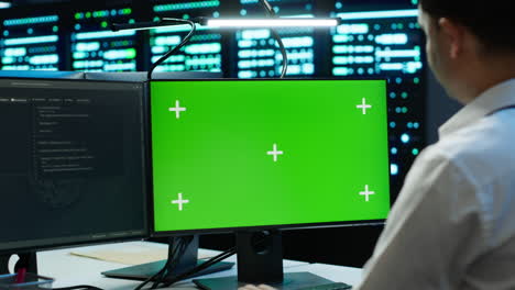 employee using green screen devices in server farm used for automation