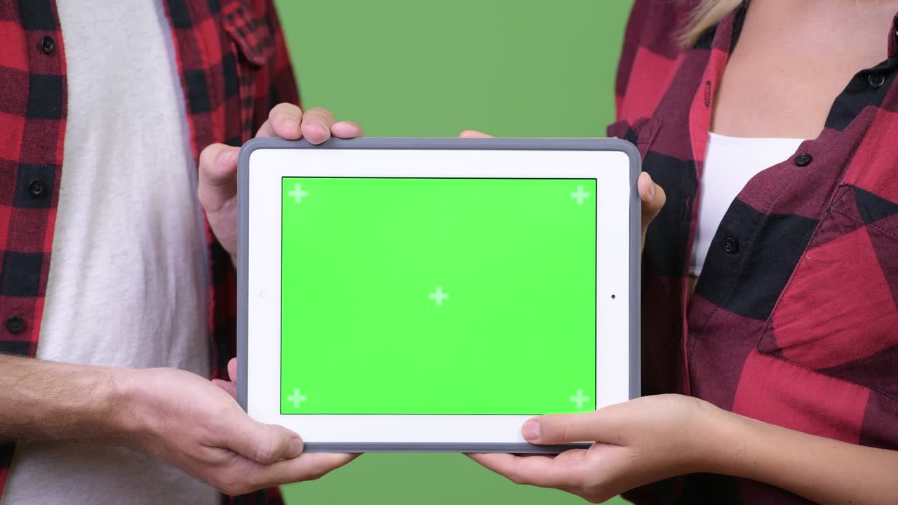 Young couple showing digital tablet together