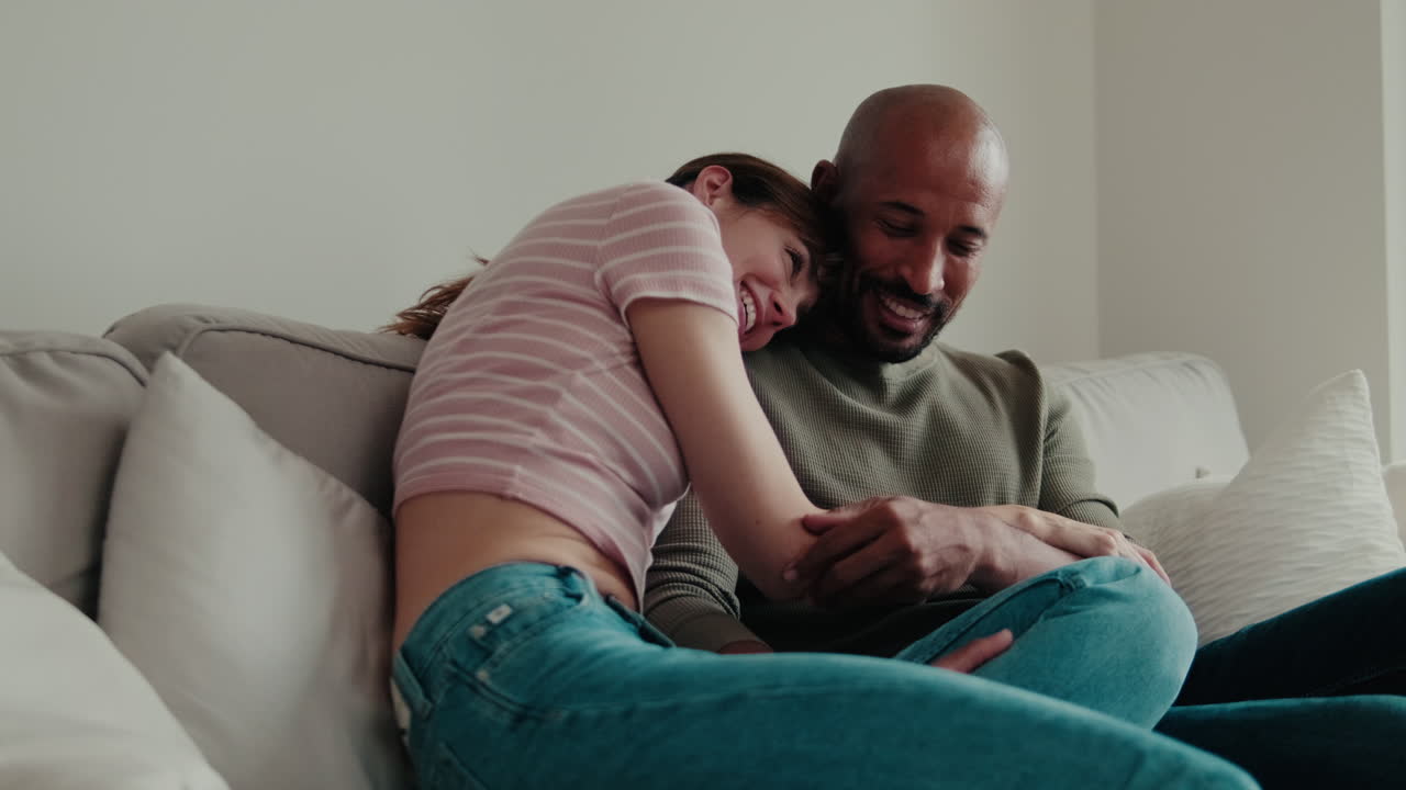 Happy Couple Cuddling on the Couch