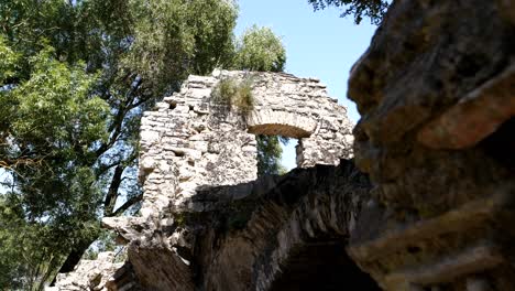 Butrint,-Albania,-view-of-ancient-Roman-buildings-amidst-green-trees