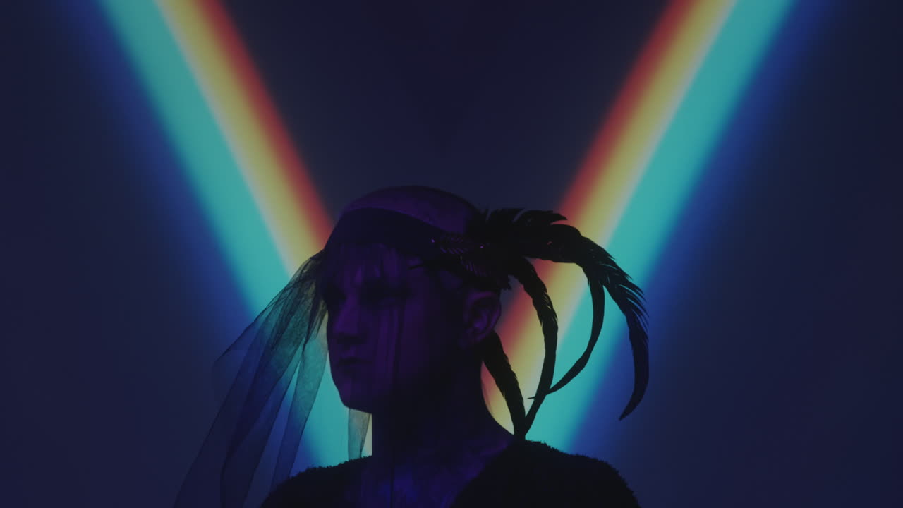 Man in Gothic Veil with Feathers in Dark Studio