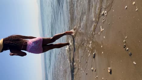 Anonymous-black-woman-walking-on-beach