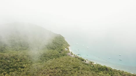 Drone-aerial-in-the-clouds-of-a-tropical-forest-Fitzroyt-island-in-Queensland-Australia