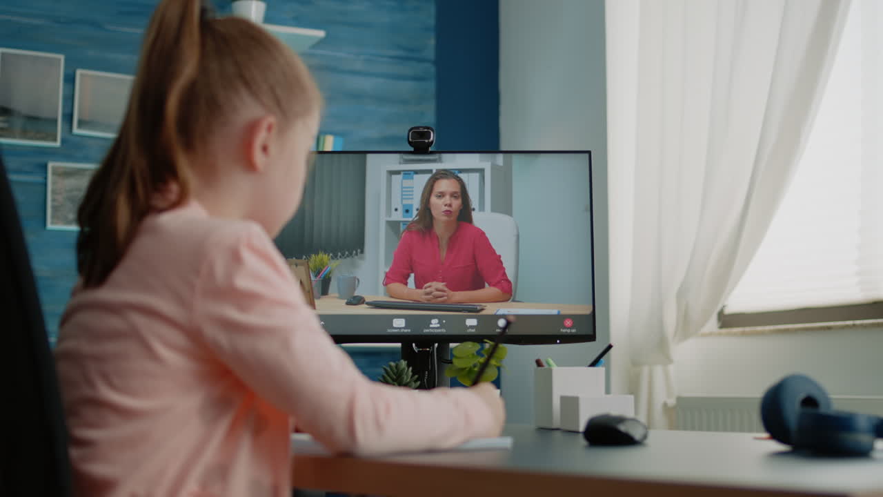 Schoolgirl and teacher using video call for remote lessons