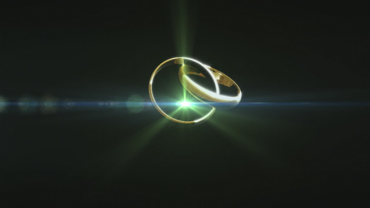 Two golden rings spinning against black background