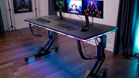 high-tech gaming desk setup with rgb lighting and multiple monitors