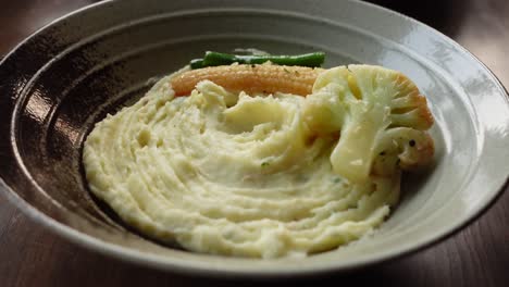 mashed potatoes in bowl on wooden rustic table