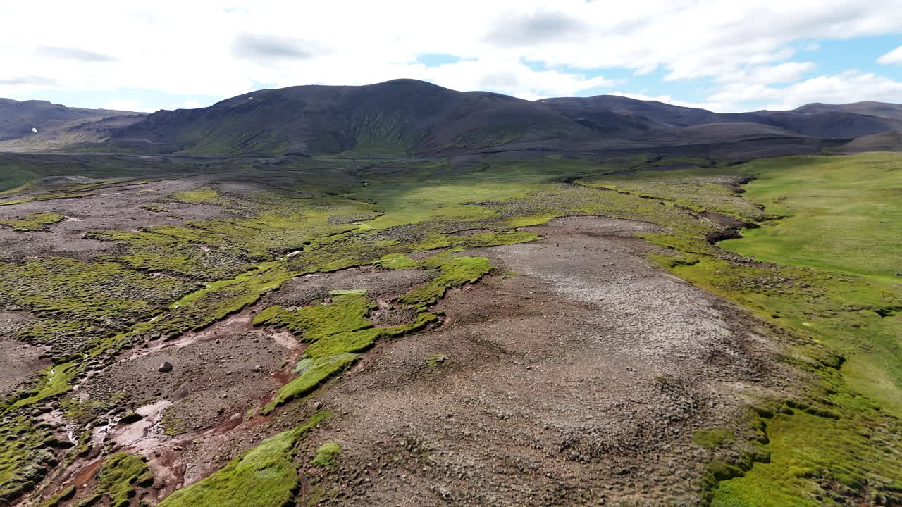 Aerial view of the highland landscape in Langanesbyggð, Iceland, showing rugged terrain, rolling hills, and wide open natural scenery