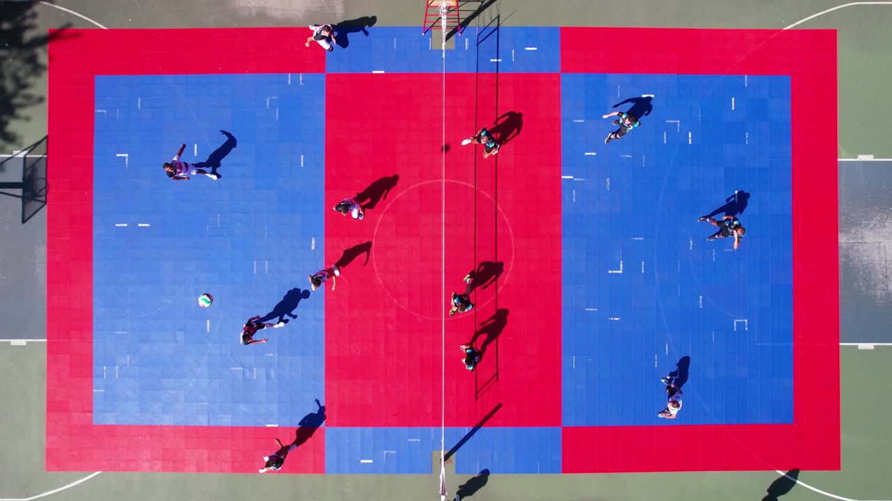 Volleyball Match at Outdoor Court, Top Down Aerial View of Teams Playing Point