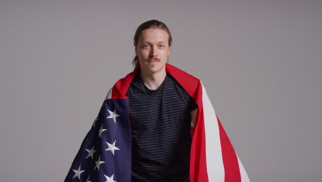 Studio-Portrait-Shot-Of-Man-Wrapped-In-American-Flag-Celebrating-4th-July-Independence-Day-7