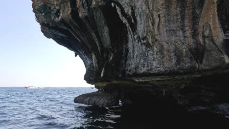 water splashing against cliff causing erosion