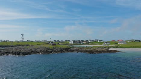 revealing drone shot of a kitesurfer in a small harbour on the isle of tiree, scotland