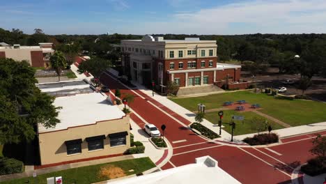 drone push in over buildings to historic city center civic building in clermont florida