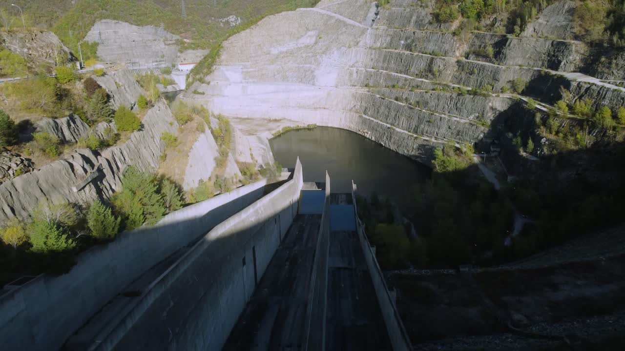 Establishing aerial of large dam in the mountains in spring