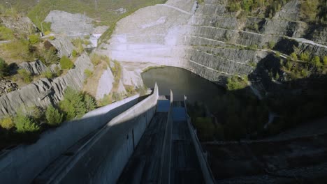 establishing aerial of large dam in the mountains in spring