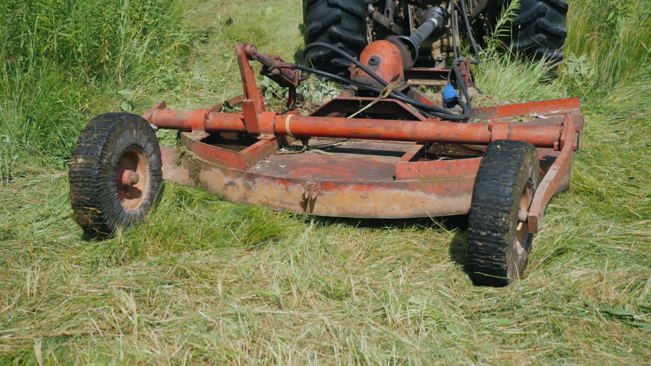 트랙터가 풀을 깎는 장치를 당깁니다