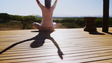 woman meditating yoga on wooden plank 4k