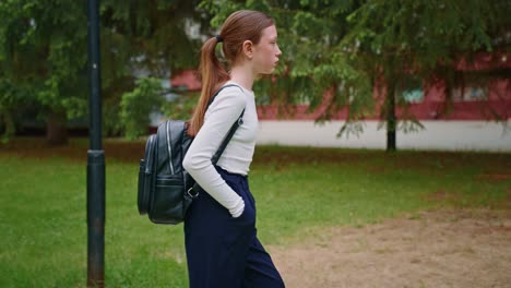 teenage girl walking in park