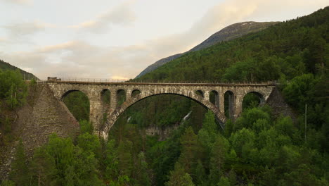 aerial view of impressive kylling stone bridge in lush rauma countryside, norway