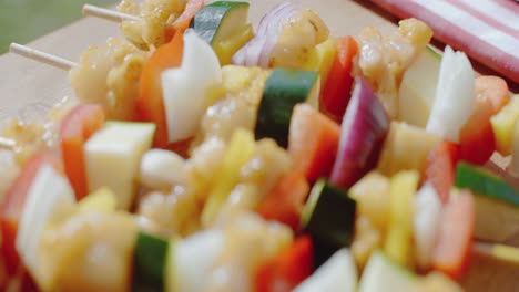 Four-chicken-and-vegetable-kabobs-on-cutting-board