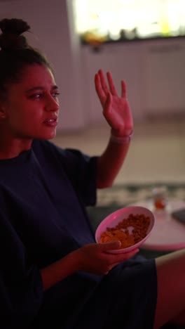 woman watching tv with snacks