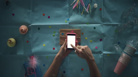 top view man using mobile phone present  birthday party planning hands from above - red epic dragon
