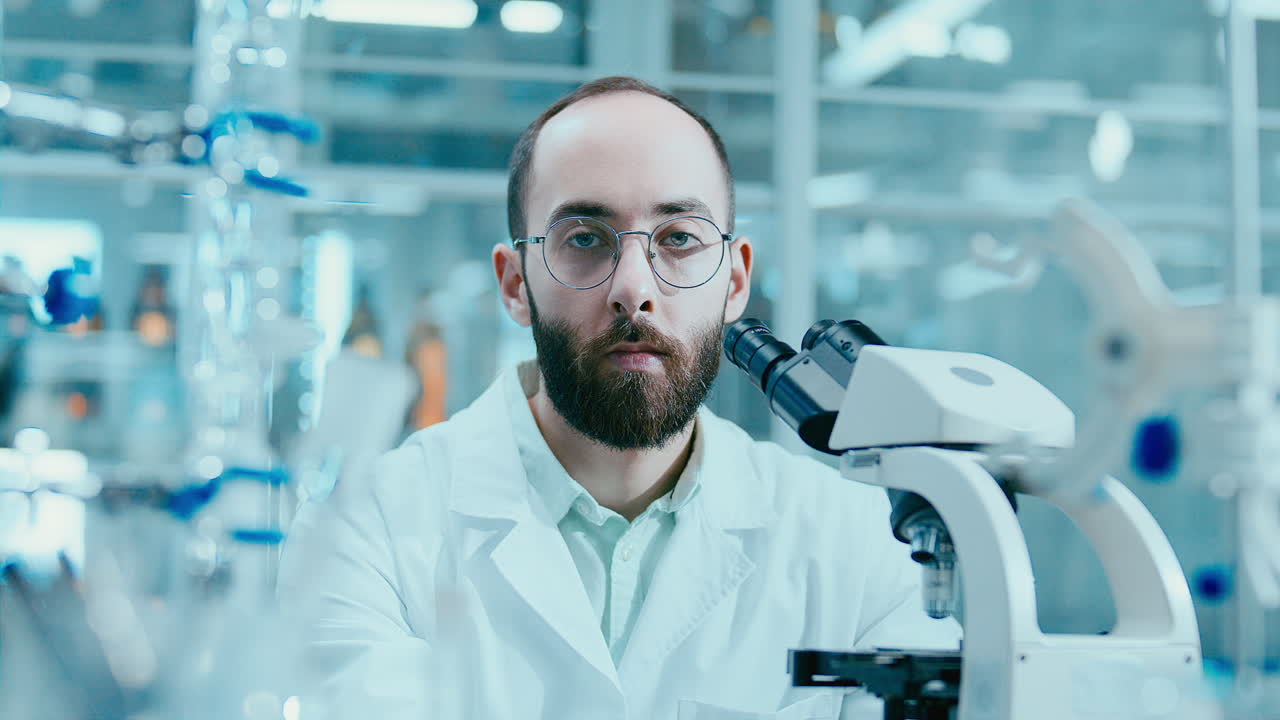 Portrait of Male Laboratory Technician Working with Microscope