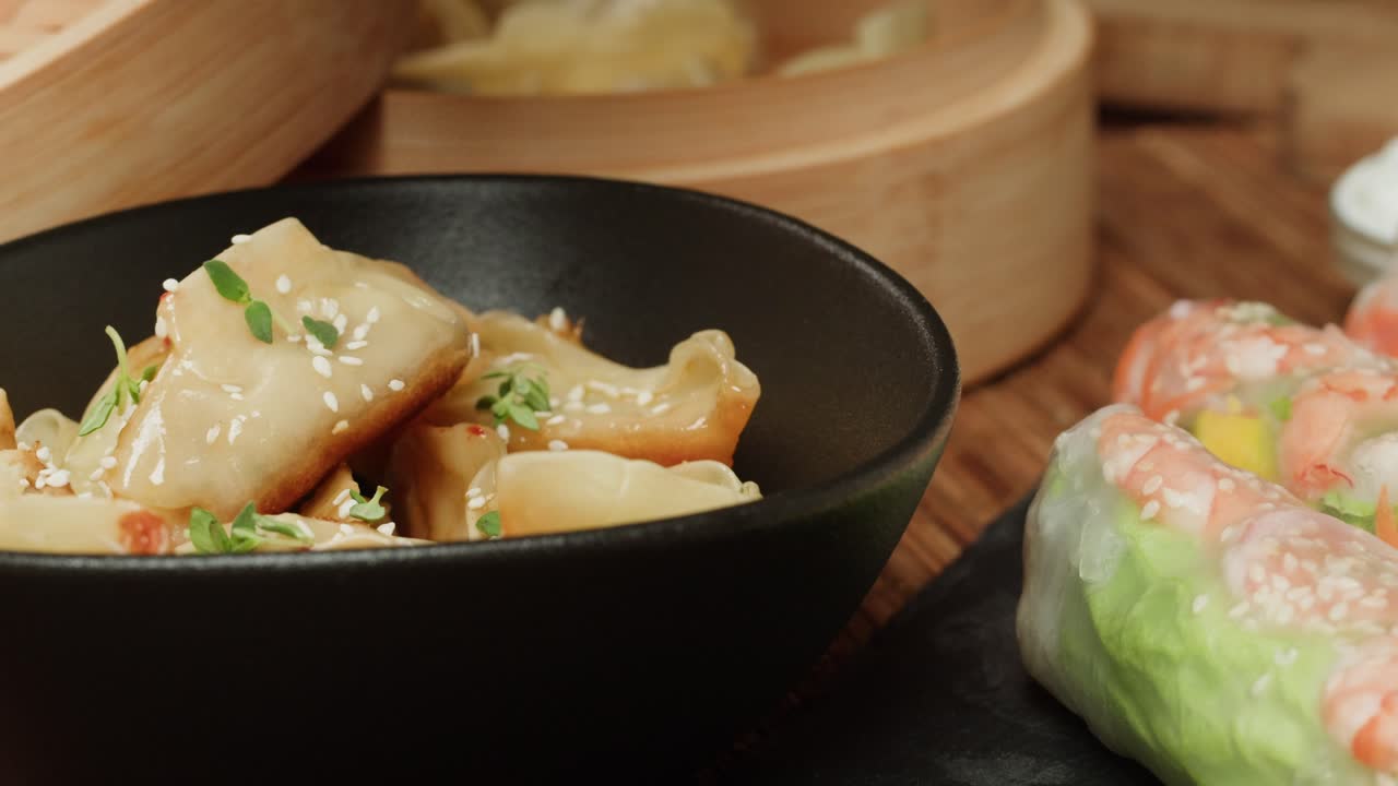 Fresh Herbs Sprinkled Over Delicious Asian Dumplings and Spring Rolls