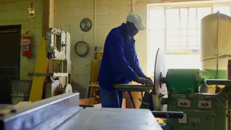 worker using sharpening machine in foundry workshop 4k