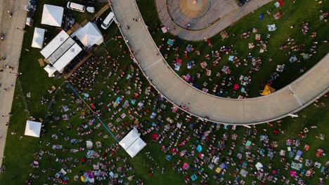 aerial view rotating above of a open air concert on the big four lawn, in louisville, usa - rising, overhead, drone shot