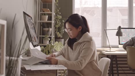 young asian woman analyzing financial data in office