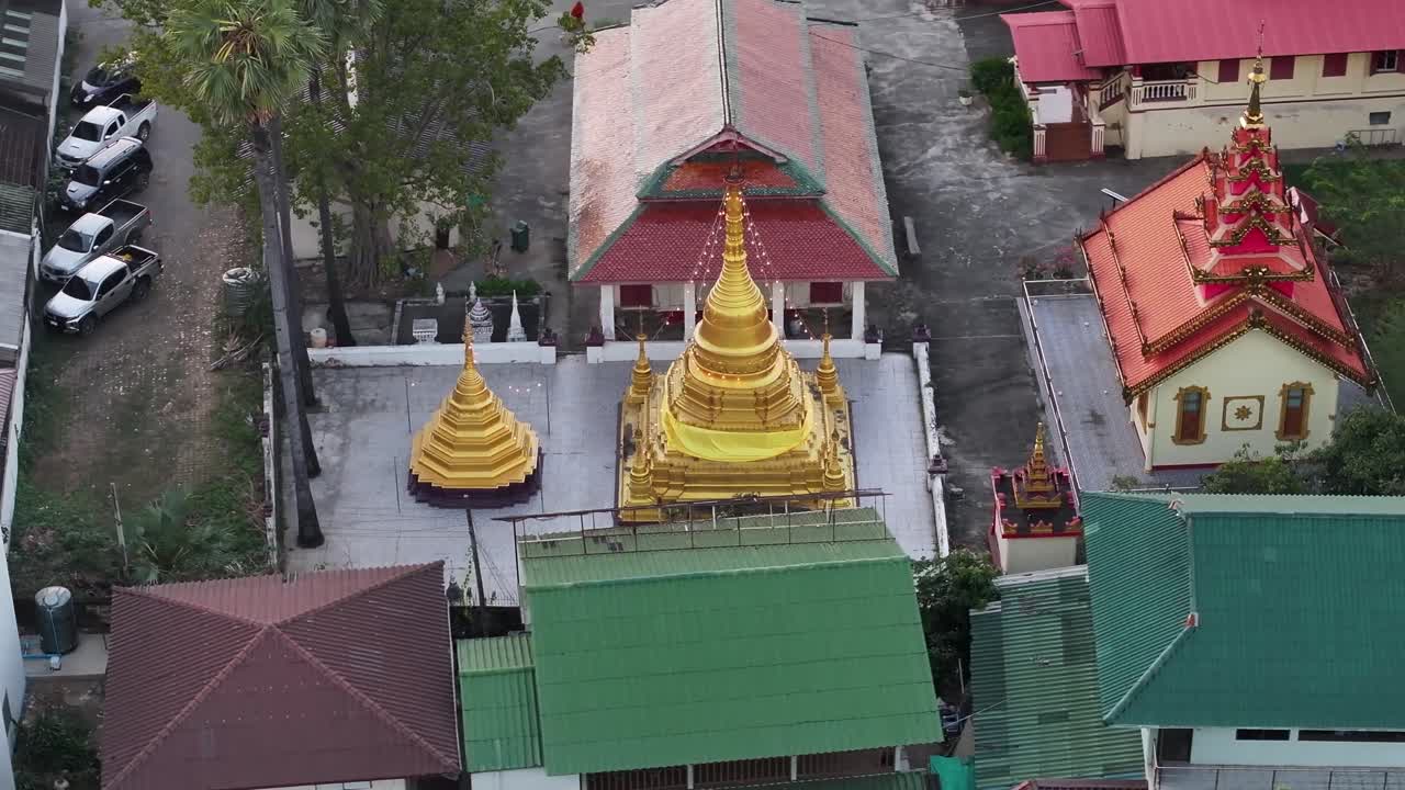 Golden pagoda and temple surroundings in Chiang Mai, Thailand. Buddhism, religion. Aerial