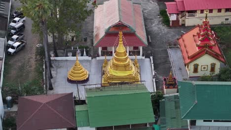 golden pagoda and temple surroundings in chiang mai, thailand. buddhism, religion. aerial