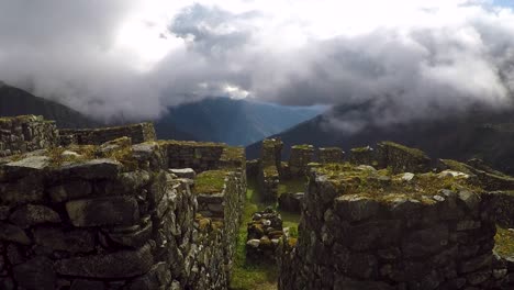 time lapse of ancient inca ruins in mountains with clouds swirling past