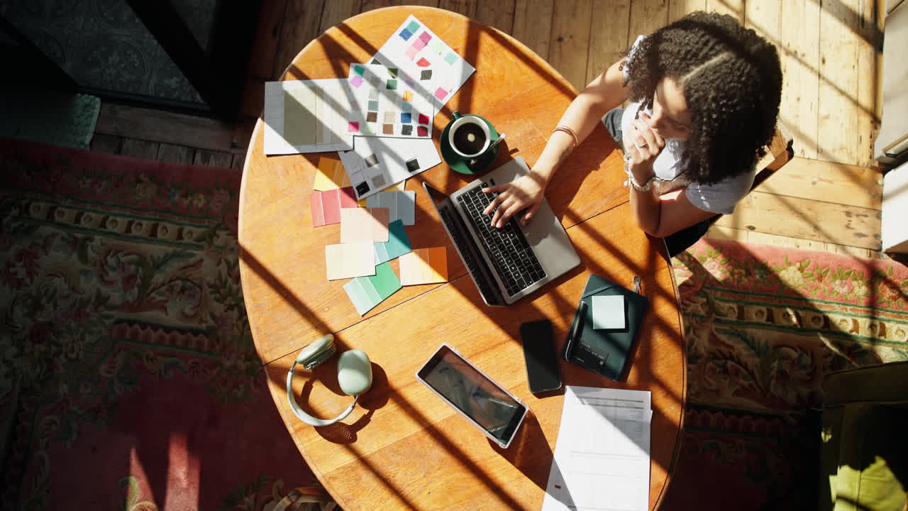 Overhead View of Woman Working on Laptop with Color Swatches