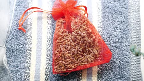 red lavender sachet on a striped towel