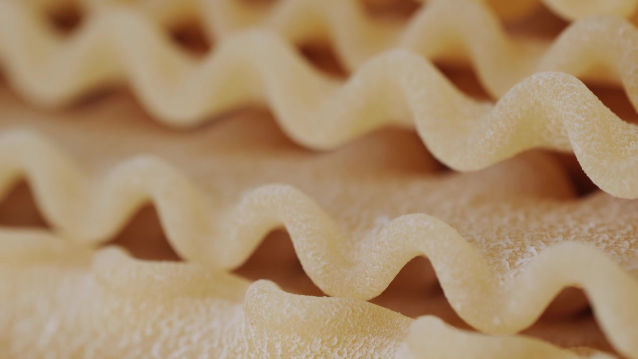 Close-up Macro Shot of Uncooked Wavy Lasagna Noodles