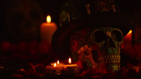 still life of decorated skull wearing hat surrounded by candles celebrating mexican holiday of dia de muertos or day of the dead 1