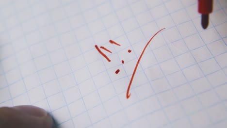 man-writes-exclamation-marks-with-red-marker-on-paper-macro