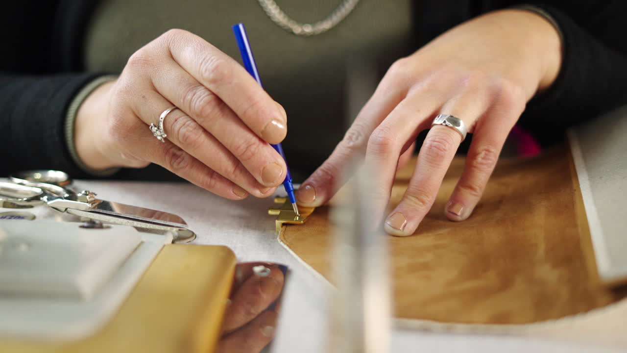 Close up of artisan working with leather