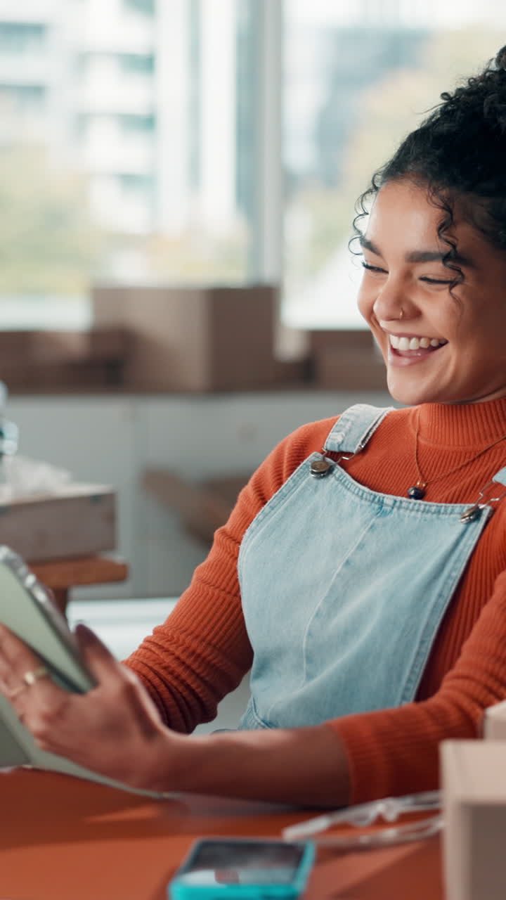 Happy Young Woman Laughing While Using a Digital Tablet