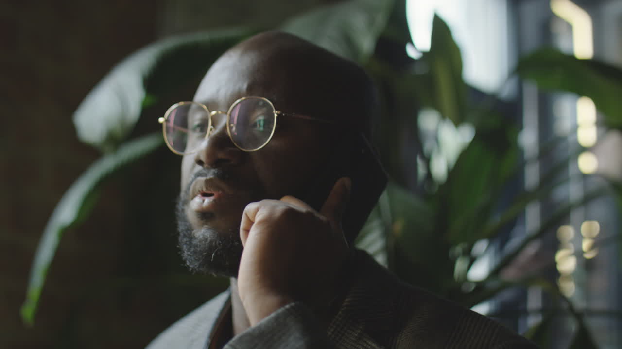 Black Businessman Speaking on Phone in Cafe