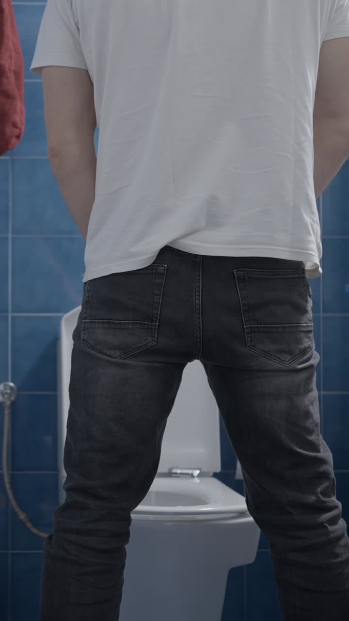 Man Urinating in a Bathroom