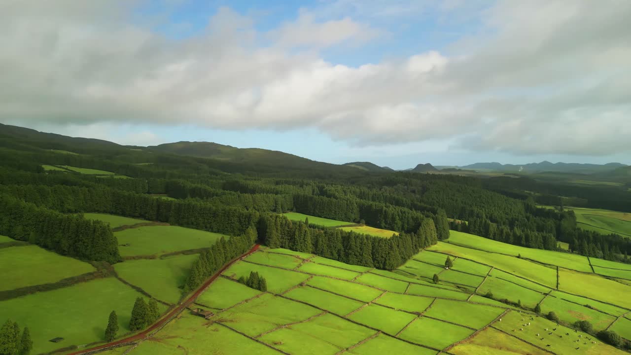 Aerial view from drone of Terceira Island - Green fields with Ilhéu das Cabras and Monte Brasil in the distance
