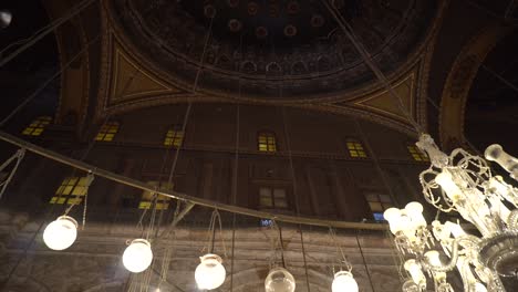 mosque of muhammad ali interior illuminated chandelier ceiling with painting of arab muslim in arch