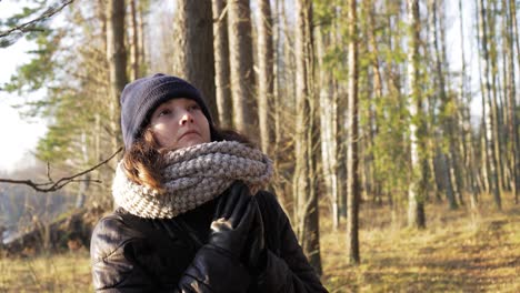 female stand and pretend to act in sunny fall forest and walk away