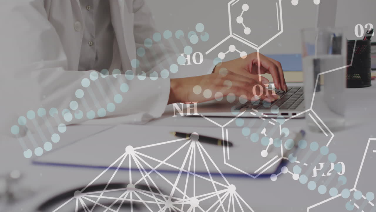 노트북을 이용한 두 인종의 여성 의사의 손 위에 있는 dna 줄무와 요소의 애니메이션