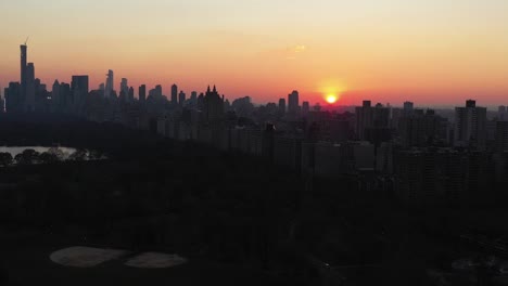 epic drone lowering into new york city's central park at gorgeous daybreak sunrise golden hour