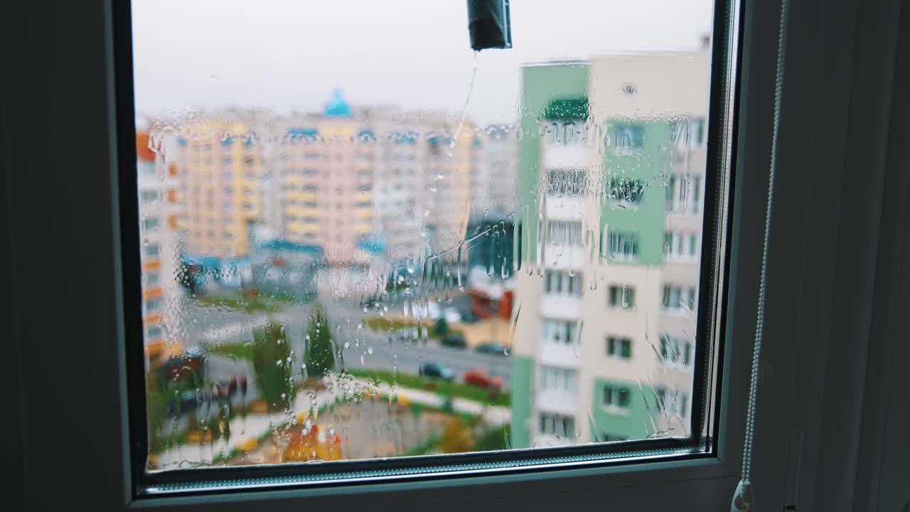 Water cleaner with wet glass. Close up view of cleaning wet window.