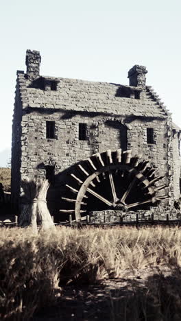 ancient stone watermill in a wheat field